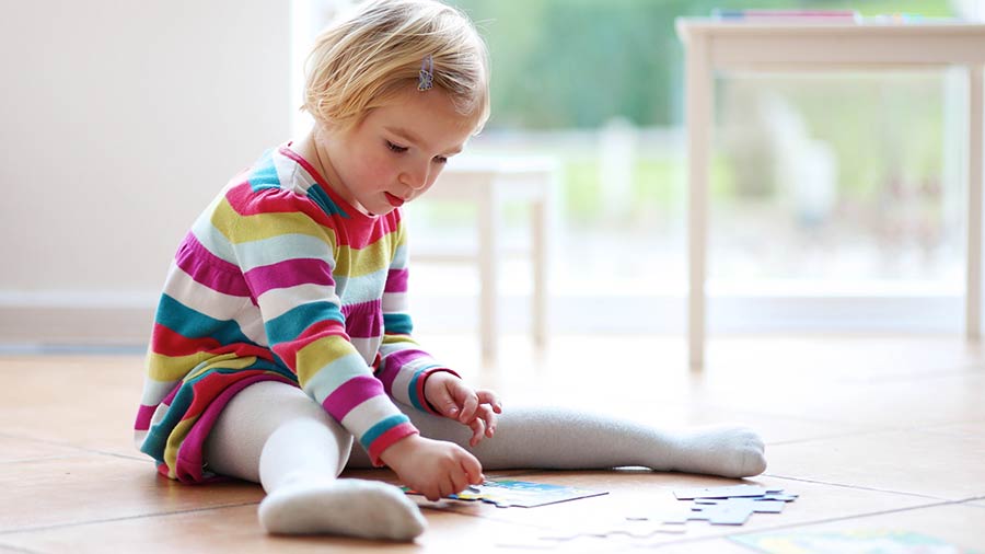 child playing on tile floor in Lawrenceville GA