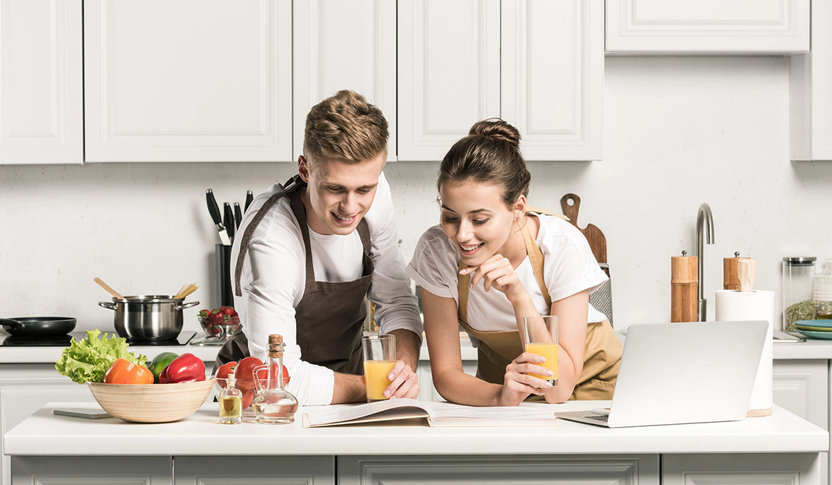 couple-reading-cookbook-in-kitchen-with-new-floor-tile-BK-Flooring-Services