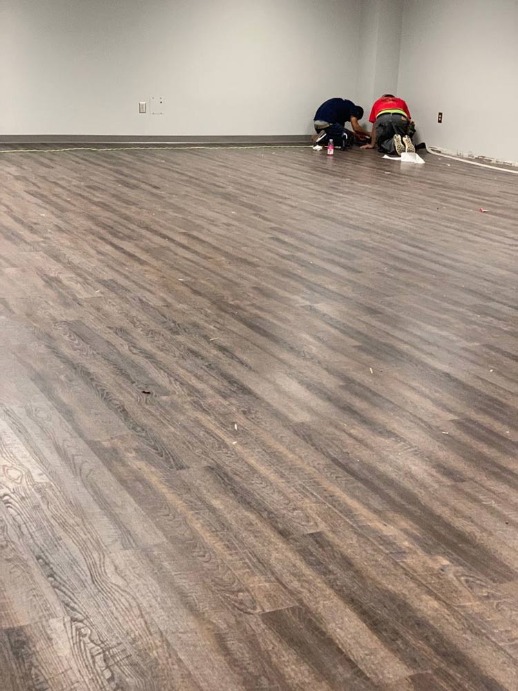 lvp-floor-being-installed-in-commercial-office-by-two-installers