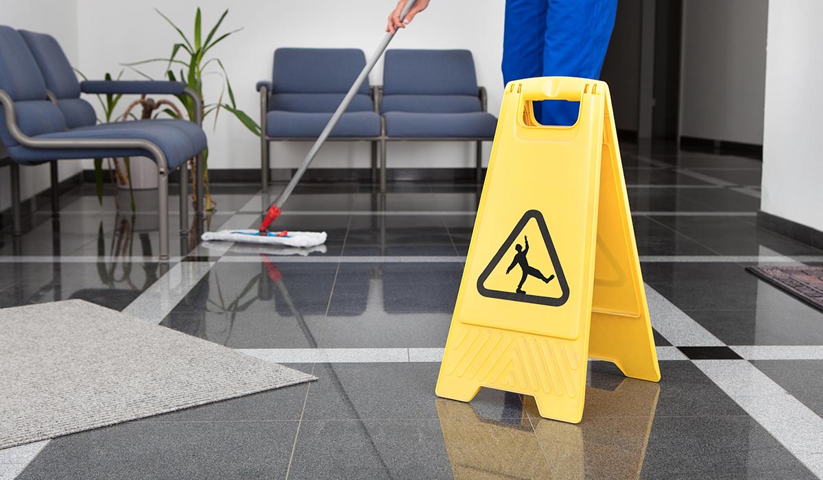 man cleaning tile floor from BK Flooring Services