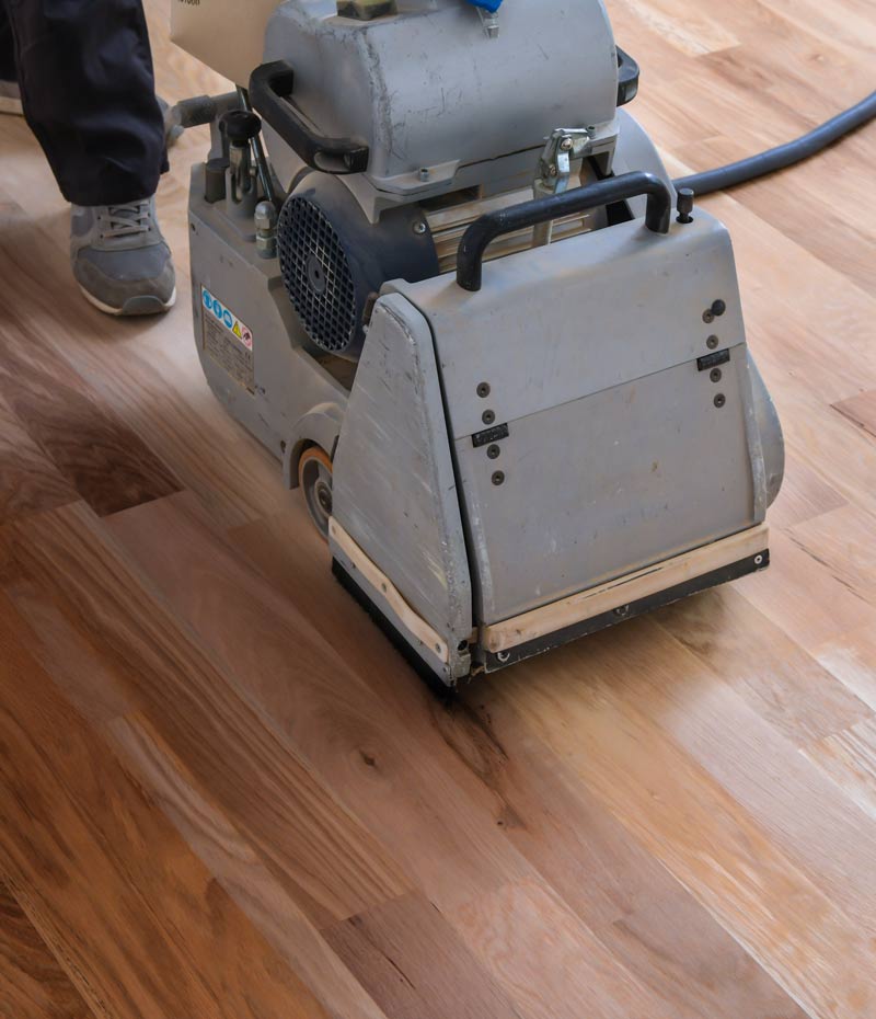 man-sanding-hardwood-floor