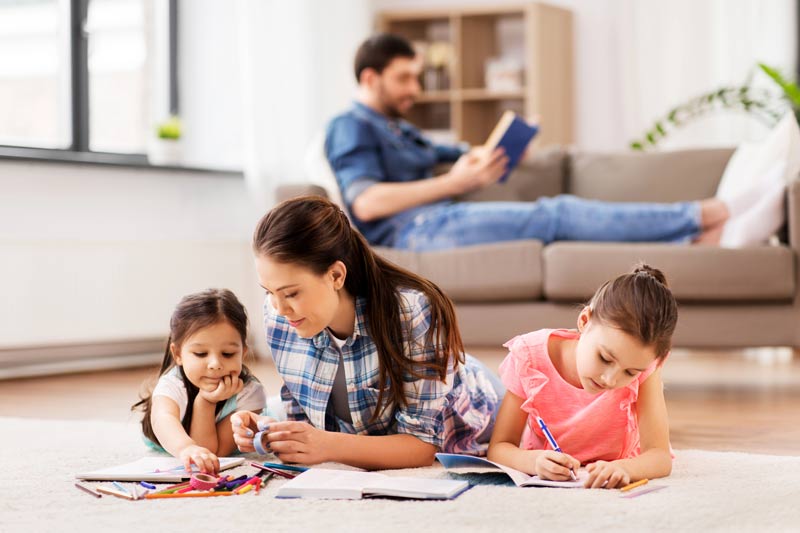 mother-with-little-daughters-drawing-at-home